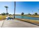 Golf course view with pond and palm trees at 14017 N 111Th Ave, Sun City, AZ 85351