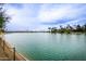 Scenic lakefront view with palm trees and calm water at 14017 N 111Th Ave, Sun City, AZ 85351