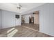 Living room with access to kitchen and light wood floors at 14017 N 111Th Ave, Sun City, AZ 85351