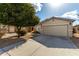 Two story house with tan exterior, two car garage, and landscaping at 1615 E Maddison Cir, San Tan Valley, AZ 85140