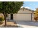 One-story house with tan exterior, two-car garage, and landscaping at 1615 E Maddison Cir, San Tan Valley, AZ 85140