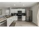 Modern kitchen with white cabinets, granite countertops, and stainless steel appliances at 1615 E Maddison Cir, San Tan Valley, AZ 85140