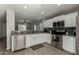 Modern kitchen with white cabinets, granite countertops, and stainless steel appliances at 1615 E Maddison Cir, San Tan Valley, AZ 85140