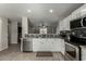 Modern kitchen with white cabinets, granite countertops, and stainless steel appliances at 1615 E Maddison Cir, San Tan Valley, AZ 85140