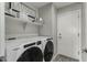 Laundry room with washer, dryer, and storage shelves at 1615 E Maddison Cir, San Tan Valley, AZ 85140