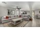 Living room with gray sectional sofa, coffee table and view of kitchen at 1615 E Maddison Cir, San Tan Valley, AZ 85140