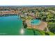 Aerial view of a lakefront clubhouse with sandy beach and pool at 1633 E Lakeside Dr # 127, Gilbert, AZ 85234