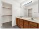 Bright bathroom featuring a double sink vanity with a mirror and walk-in closet at 1633 E Lakeside Dr # 127, Gilbert, AZ 85234