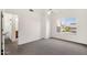 Bedroom with carpeted floors, ceiling fan, a window, and a view of an open doorway at 1633 E Lakeside Dr # 127, Gilbert, AZ 85234