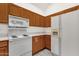 Kitchen with white appliances and laminate countertops with wooden cabinets at 1633 E Lakeside Dr # 127, Gilbert, AZ 85234