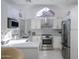 Modern white kitchen with stainless steel appliances and marble counters at 1633 E Lakeside Dr # 45, Gilbert, AZ 85234