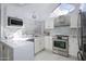 Modern white kitchen with stainless steel appliances and marble counters at 1633 E Lakeside Dr # 45, Gilbert, AZ 85234