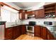 Modern kitchen with dark wood cabinets and granite countertops at 17149 E El Pueblo Blvd, Fountain Hills, AZ 85268