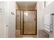 Contemporary bathroom with a tiled shower featuring a glass door and bronze hardware at 17850 N 68Th St # 3120, Phoenix, AZ 85054