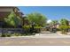 Inviting entrance to Monterey Ridge with a stone sign, lush greenery, and palm trees at 17850 N 68Th St # 3120, Phoenix, AZ 85054