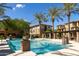 Community pool featuring clear blue water, palm trees, lounge chairs, and nearby apartments on a clear, sunny day at 17850 N 68Th St # 3120, Phoenix, AZ 85054