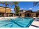 Community pool featuring clear blue water, palm trees, lounge chairs, and a pool house on a clear, sunny day at 17850 N 68Th St # 3120, Phoenix, AZ 85054