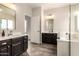 Bathroom with dark vanity, tile floor, and soaking tub at 1820 N 94Th Gln, Phoenix, AZ 85037