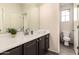 Modern bathroom with dark vanity, white countertop, and toilet at 1820 N 94Th Gln, Phoenix, AZ 85037