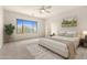 Relaxing bedroom with large windows, plush bedding, and ample natural light at 1820 N 94Th Gln, Phoenix, AZ 85037