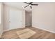 Bedroom with light walls, wood-look floors, and a sliding door at 19430 E Erik Ct, Florence, AZ 85132