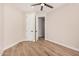 Bedroom featuring wood-look floors and access to another room at 19430 E Erik Ct, Florence, AZ 85132