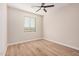 Bedroom with wood-look floors, window with blinds and ceiling fan at 19430 E Erik Ct, Florence, AZ 85132