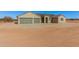 Tan house with three-car garage and desert landscaping at 19430 E Erik Ct, Florence, AZ 85132