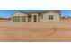 Tan house with three-car garage and desert landscaping at 19430 E Erik Ct, Florence, AZ 85132