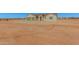 Tan house with three-car garage and desert landscaping at 19430 E Erik Ct, Florence, AZ 85132