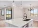 Island kitchen with white cabinets and a modern faucet at 19430 E Erik Ct, Florence, AZ 85132