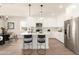 Modern kitchen with white cabinets, stainless steel appliances, a center island, and stylish pendant lighting at 19430 E Erik Ct, Florence, AZ 85132