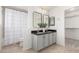 Modern bathroom with double sinks, gray cabinets, and walk-in shower at 1956 W Black Hill Rd, Phoenix, AZ 85085