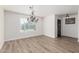 Bright dining room with chandelier, hardwood floors, and access to entryway at 1956 W Black Hill Rd, Phoenix, AZ 85085