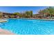 Inviting community pool with a spacious deck and lounge chairs at 1956 W Black Hill Rd, Phoenix, AZ 85085