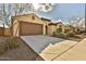 Brown garage door and driveway of a one-story house at 19587 W Marshall Ave, Litchfield Park, AZ 85340