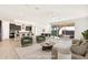 Bright, open-concept living room featuring a kitchen, dining area and sliding glass doors to the outside patio at 19587 W Marshall Ave, Litchfield Park, AZ 85340