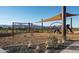 Community playground with shade structure and swings at 19587 W Marshall Ave, Litchfield Park, AZ 85340