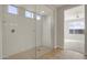 Large walk-in shower with glass enclosure and tiled walls at 19587 W Marshall Ave, Litchfield Park, AZ 85340