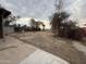 Backyard with dirt, sparse vegetation and a tree at 215 S 32Nd Dr, Phoenix, AZ 85009