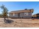 Gray house with chain link fence and a tree in front at 21701 W Griffin Ave, Wittmann, AZ 85361