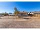 House with chain link fence and gravel driveway at 21701 W Griffin Ave, Wittmann, AZ 85361