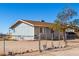 Gray house with chain link fence, and small yard at 21701 W Griffin Ave, Wittmann, AZ 85361