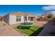 View of the home's backyard with brick patio and trampoline at 22235 E Cherrywood Dr, Queen Creek, AZ 85142