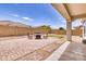 Relaxing patio area with fire pit and artificial turf at 22235 E Cherrywood Dr, Queen Creek, AZ 85142