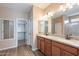 Bathroom featuring double vanity, wood floors, and a walk-in shower at 22235 E Cherrywood Dr, Queen Creek, AZ 85142