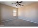 This bedroom includes a ceiling fan and a window at 22235 E Cherrywood Dr, Queen Creek, AZ 85142