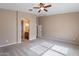 Neutral bedroom features carpeted floors, ceiling fan, and arched doorway at 22235 E Cherrywood Dr, Queen Creek, AZ 85142