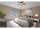 Virtually staged bedroom with modern decor, natural light, and blinds at 22235 E Cherrywood Dr, Queen Creek, AZ 85142