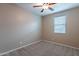 Cozy bedroom features a ceiling fan and window at 22235 E Cherrywood Dr, Queen Creek, AZ 85142